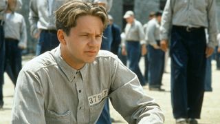 Tim Robbins sits in a prison in The Shawshank Redemption