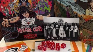 Dungeons & Dragons Welcome to the Hellfire Club box, DM screen, dice, and prop photo laid out on a table