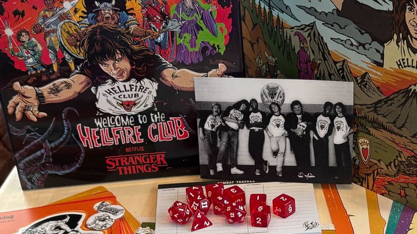 Dungeons &amp; Dragons Welcome to the Hellfire Club box, DM screen, dice, and prop photo laid out on a table