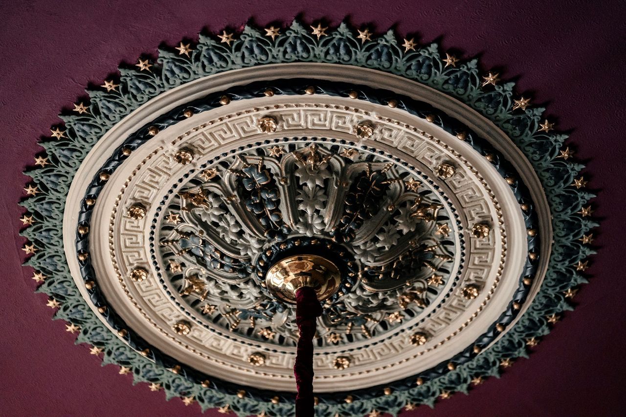 The top of the chandelier shows detailed worked done to renovate it