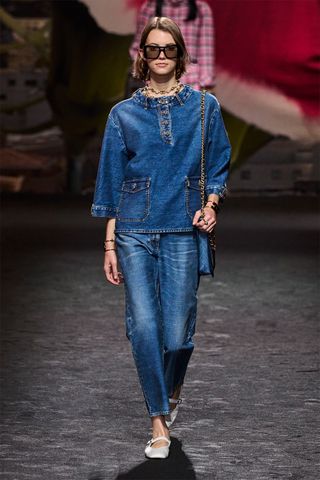 Denim shirt outfit on the runway.