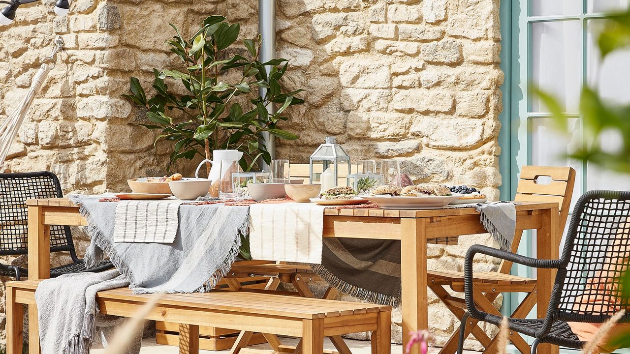 stone cottage with outdoor dining area by B&amp;Q