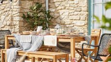 stone cottage with outdoor dining area by B&Q