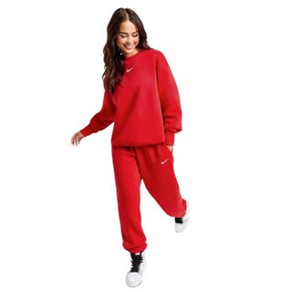 woman wearing red nike tracksuit