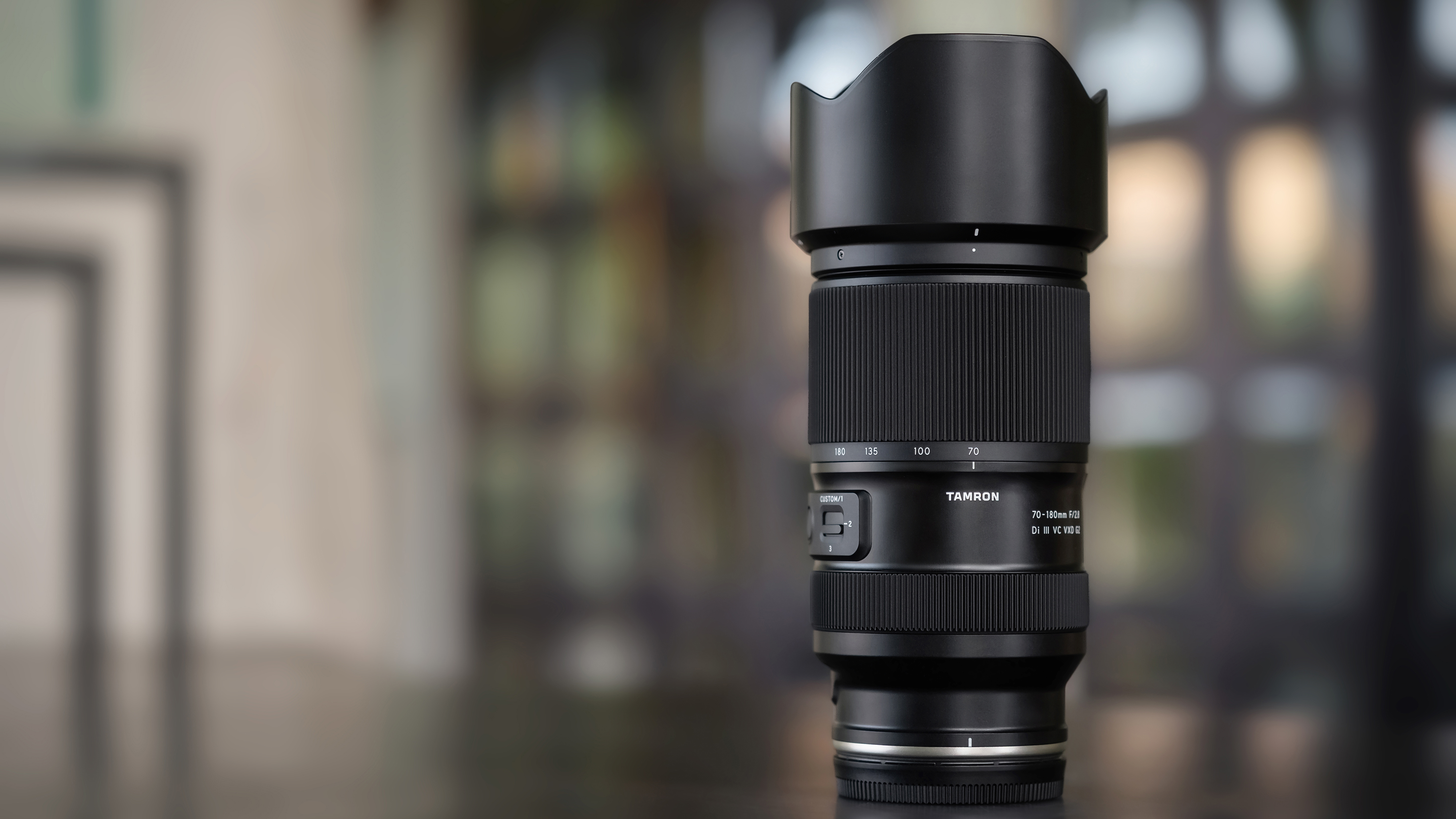 The Tamron 70-180mm f/2.8 G2 lens on a tabletop