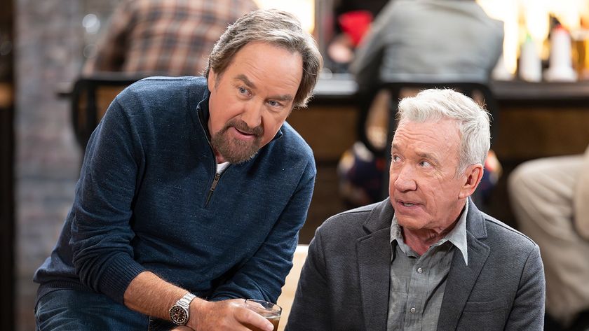 Season 2 Shifting Gears Press image of Richard Karn in a blue shirt sharing a drink with Tim Allen in a button down and grey suit coat.