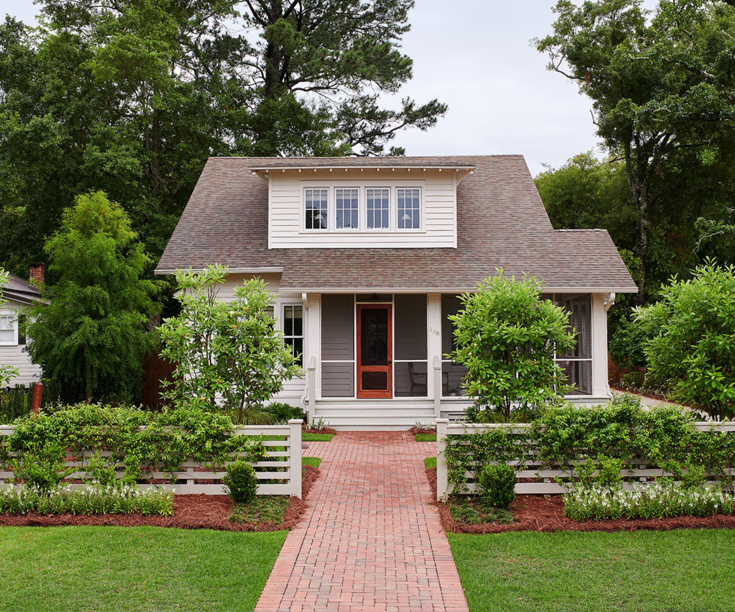 Shiplapped cottage painted in warm white