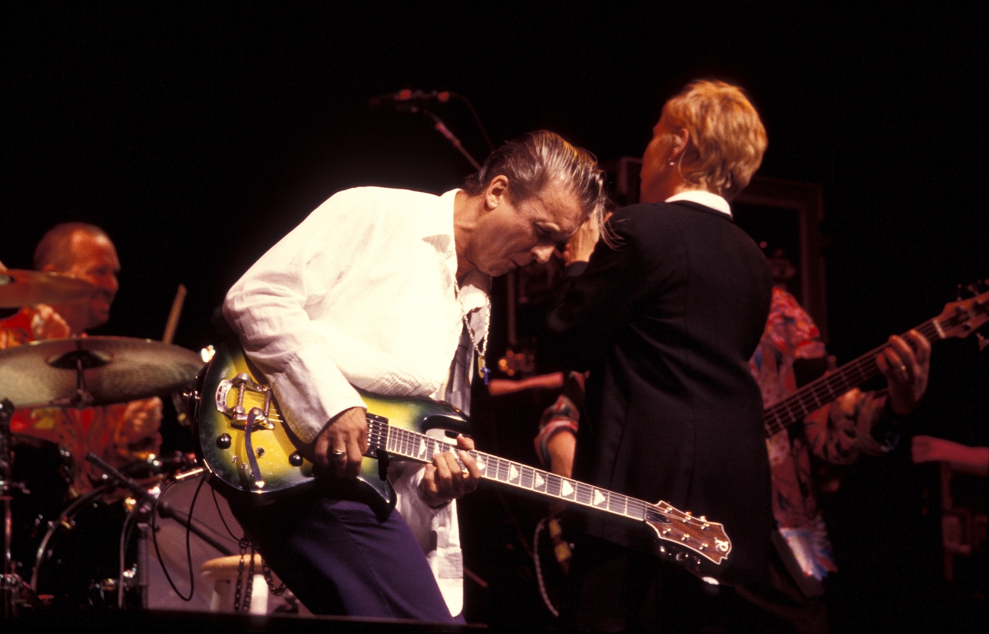 Neil Geraldo (left, foreground) and Pat Benatar, performing on stage in Wallingford, Connecticut on June 18, 1997