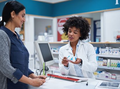 Shot of a pharmacist assisting a customer in a chemist