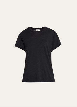 a black t shirt in front of a plain backdrop 