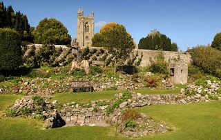 The ruins of Shaftesbury Abbey Dorset UK with a statue of King Alfred and the shrine which once housed the relics believed to be