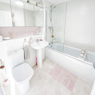 bathroom with white sink and bathtub