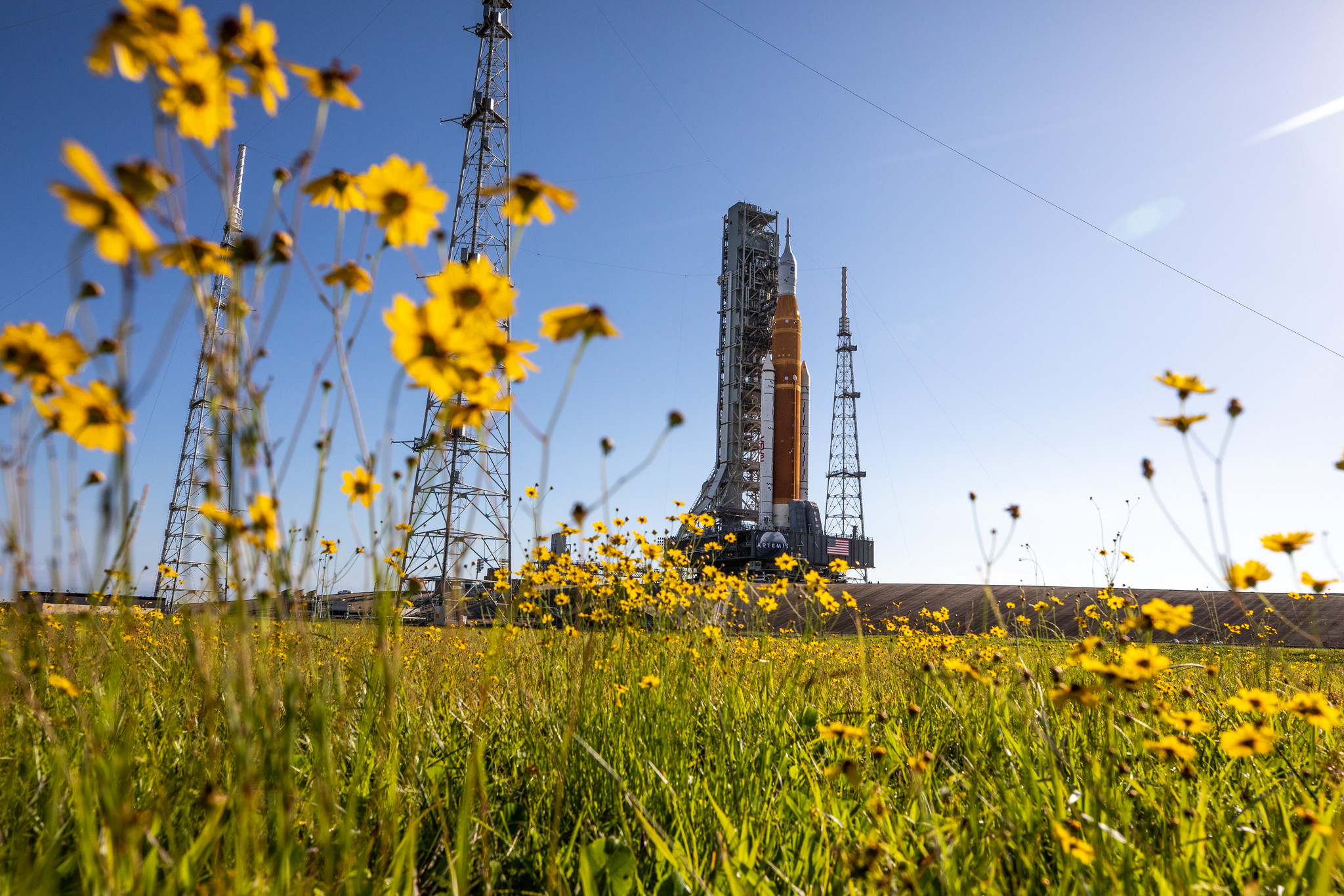 With wildflowers surrounding the view, NASA's Artemis 1 moon rocket — carried atop the agency's crawler-transporter 2 — arrives at Launch Pad 39B at the agency’s Kennedy Space Center in Florida on June 6, 2022.