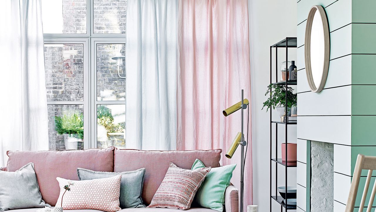 Living room with pink sofa and pink and green sheer curtains