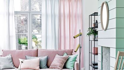 Green living room with pink sofa and pink and green sheer curtains