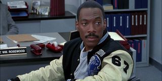 Beverly Hills Cop III Axel Foley smirking at his desk