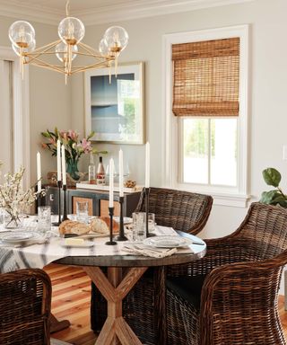 Cream dining room with oval table and dark wicker armchairs