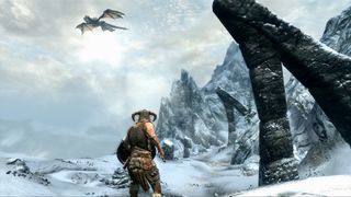A warrior faces off against a dragon in the frozen mountains of Skyrim