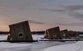 An outside view of the cabins at Arctic Bath — Lapland, Sweden