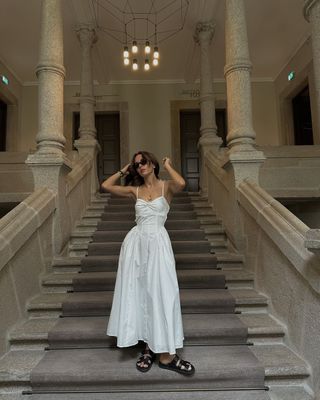 @deborabrosa wearing a white dress with black shoes