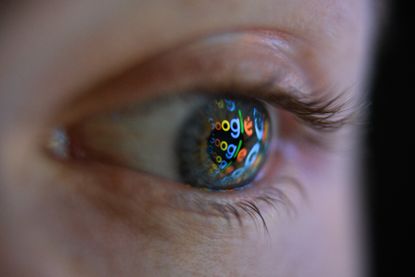 The Google logo reflected in person's eye.