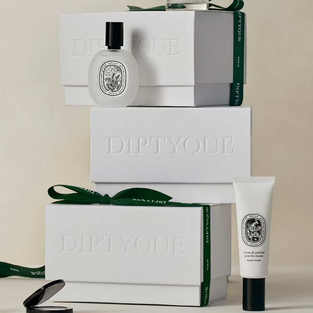 Diptyque perfume and hand cream on diptyque boxes with green ribbon
