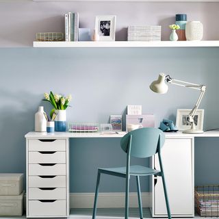 home office with teal colour wall and white desk