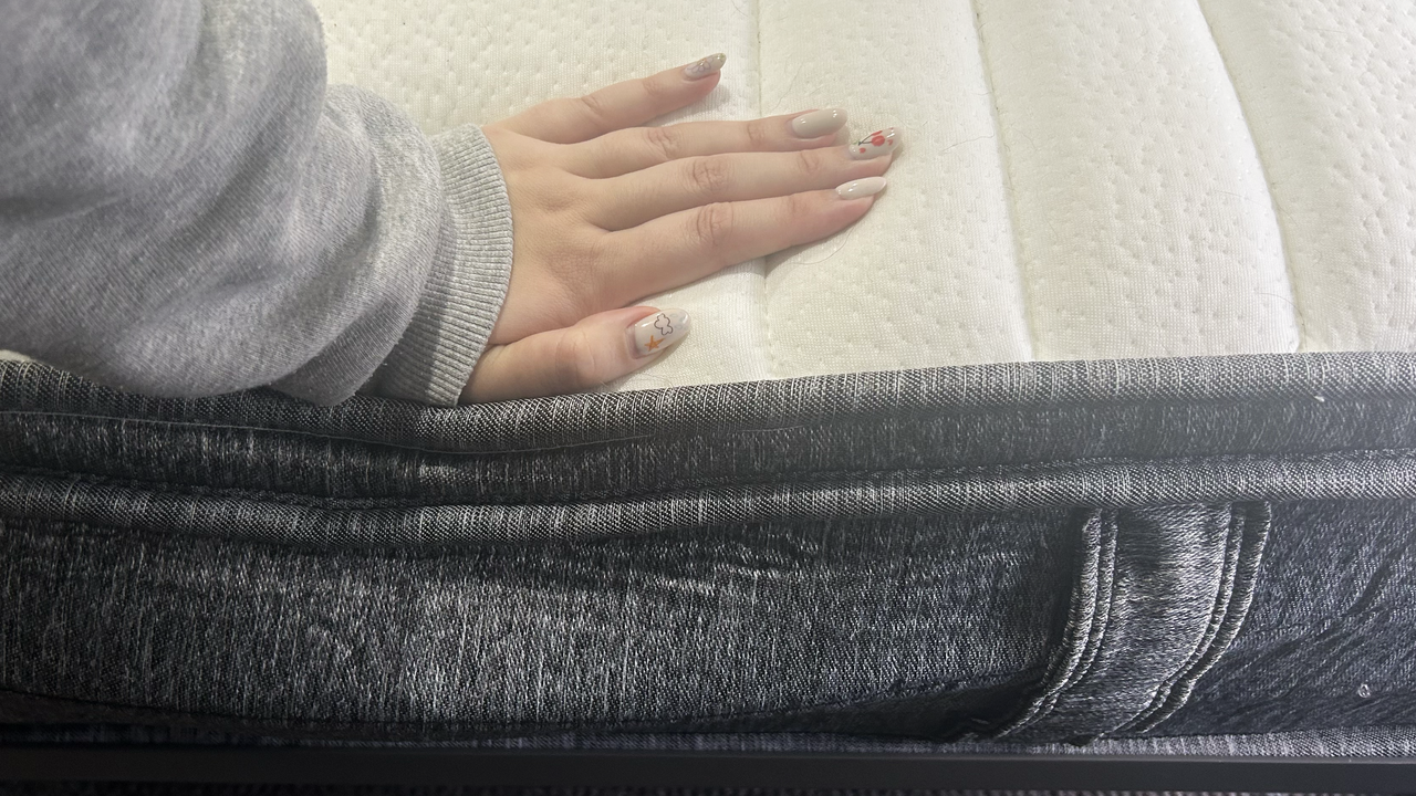 Hand pushing on top of mattress
