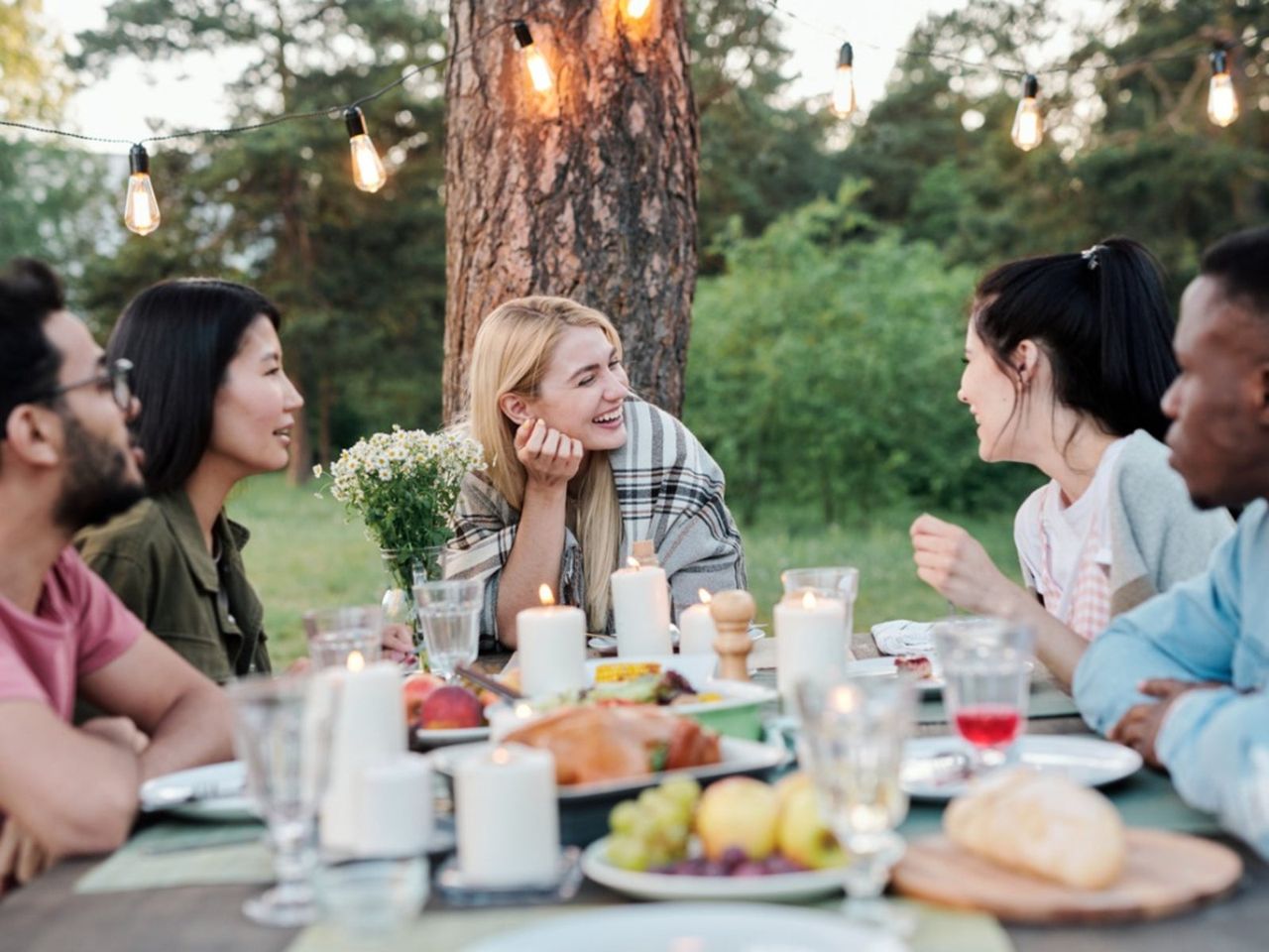 People Dining Outdoors In The Garden