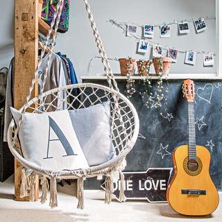 bedroom with blackboard, swing chair and guitar