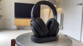 Fractal Scape headphone in their charging dock, sat on a table