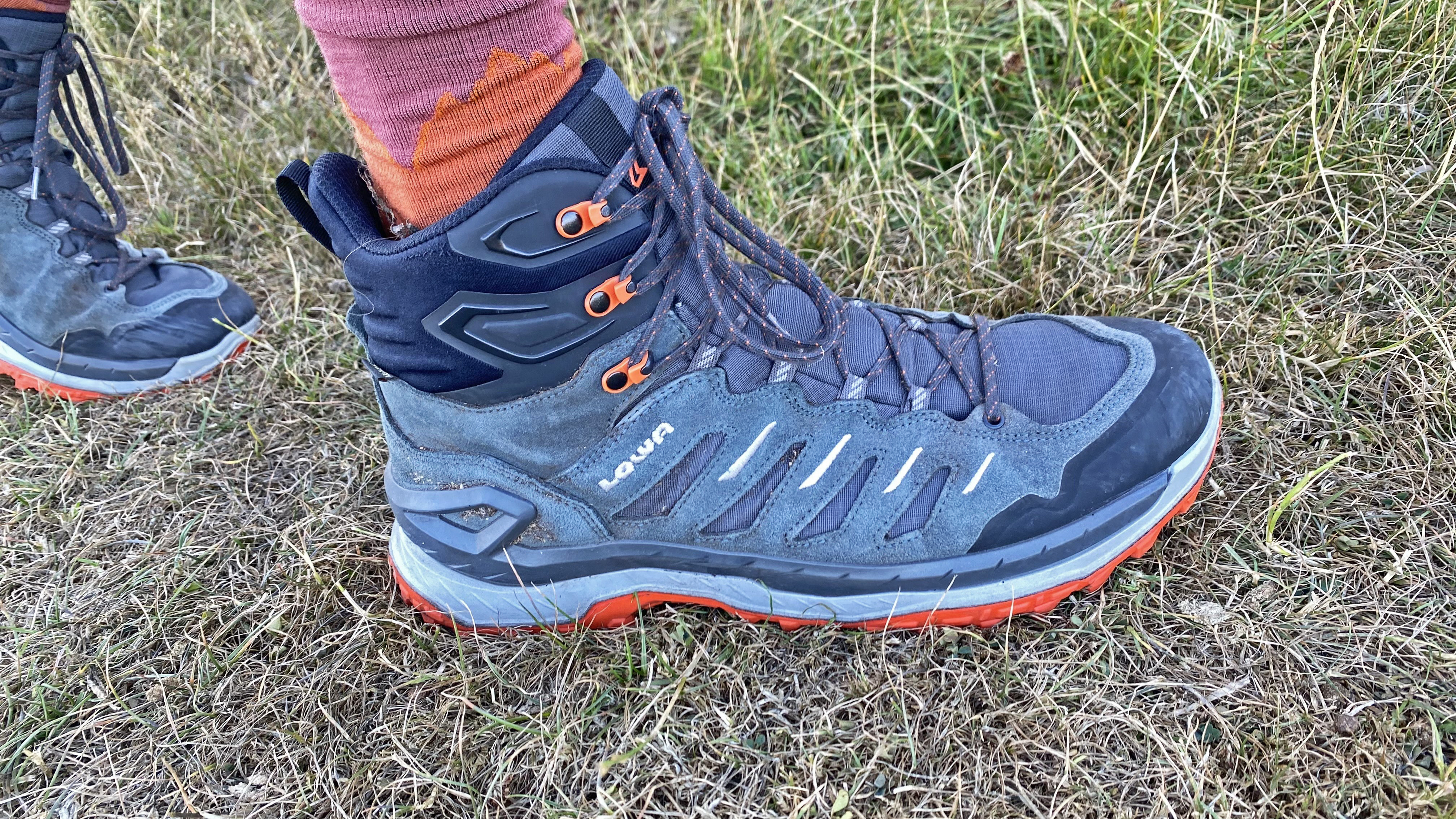 Lowa Innovo Mid GTX hiking boots worn on a grassy trail