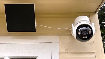 IMOU AOV PT security camera mounted on wall with solar panel