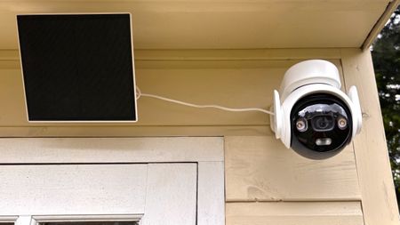 IMOU AOV PT security camera mounted on wall with solar panel