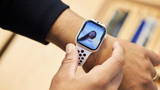 A person trying on an Apple Watch Series 8 in an Apple Store.