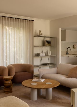 A living room with brown armchairs