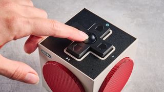 A beige, red and black 8BitDo Retro Cube 2 Bluetooth speaker