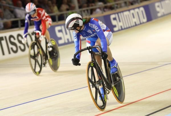 Victoria Baranova (Russia) watches Britain's Victoria Pendleton in their sprint heat.
