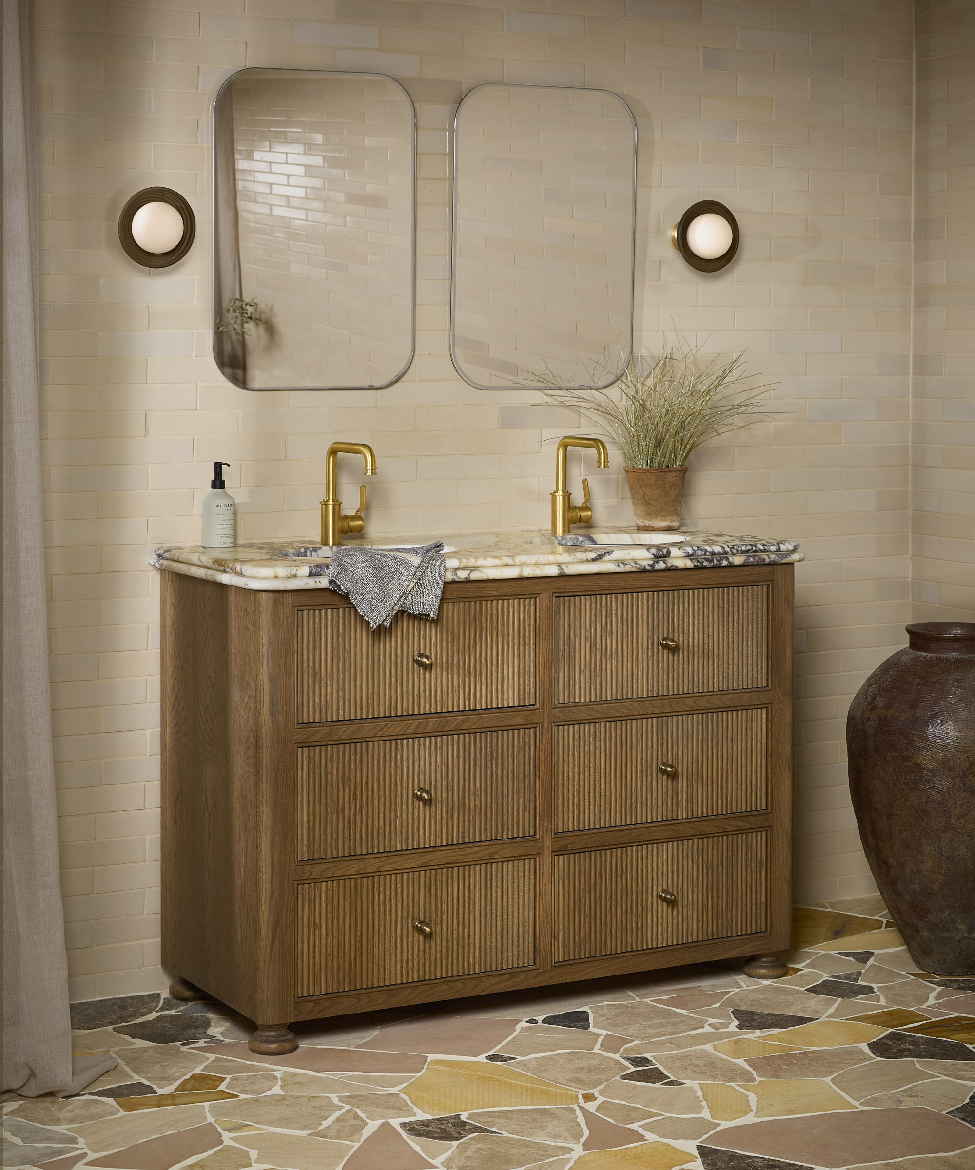 bathroom with tiled floor, walls and wooden vanity with marble top