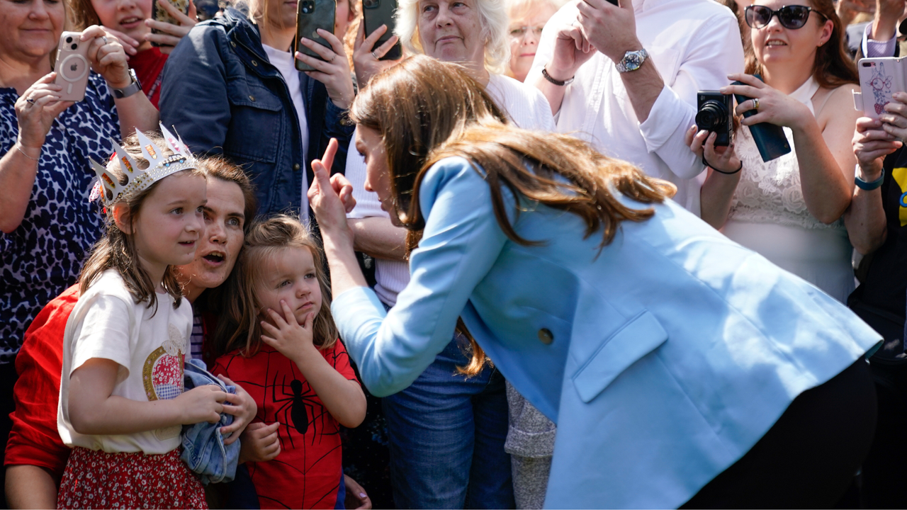 Catherine, Princess of Wales speaks to a group of children during a walkabout meeting members of the public on the Long Walk near Windsor Castle, where the Coronation Concert to celebrate the coronation of King Charles III and Queen Camilla is being held this evening on May 7, 2023 in Windsor, England. The Coronation of Charles III and his wife, Camilla, as King and Queen of the United Kingdom of Great Britain and Northern Ireland, and the other Commonwealth realms took place yesterday at Westminster Abbey today. Charles acceded to the throne on 8 September 2022, upon the death of his mother, Elizabeth II.