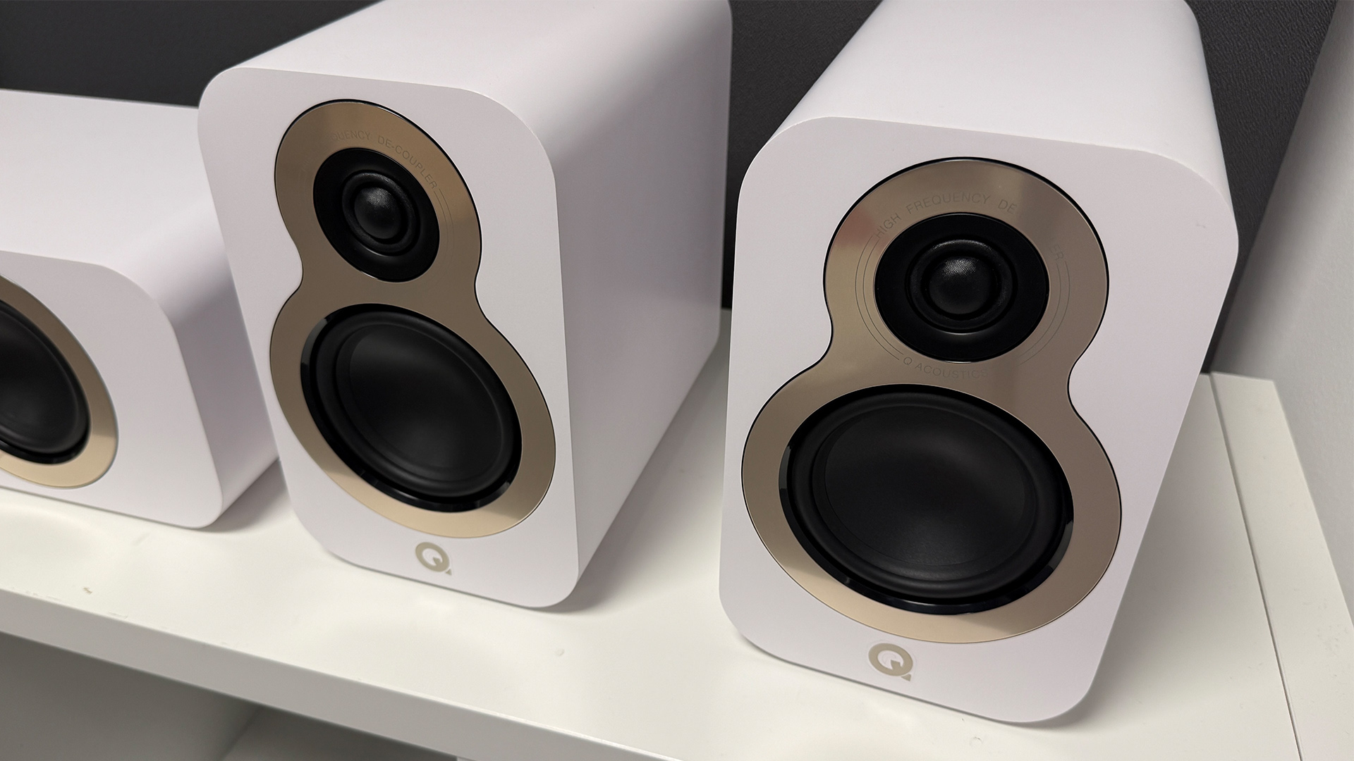 Q Acoustics 3050c 5.1 home cinema speaker package surround speakers on white wooden shelving unit