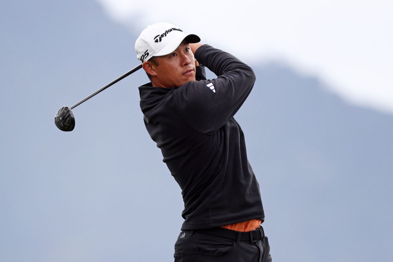 Collin Morikawa hits a fairway wood off the tee