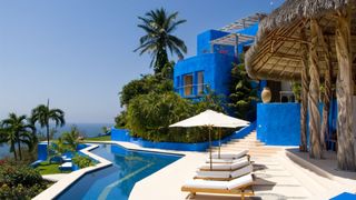 Swimming pool, Resort, Property, Vacation, Building, Sunlounger, Real estate, House, Architecture, Outdoor furniture,