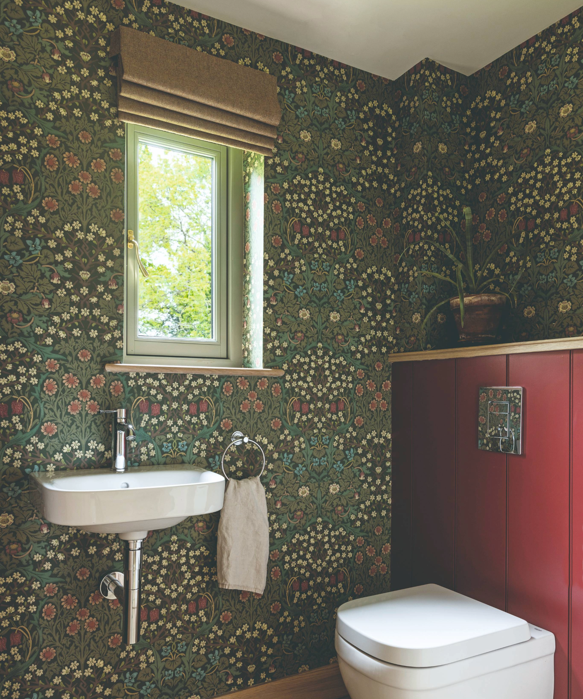 Understairs toilet idea with green floral wallpaper and red toilet cover