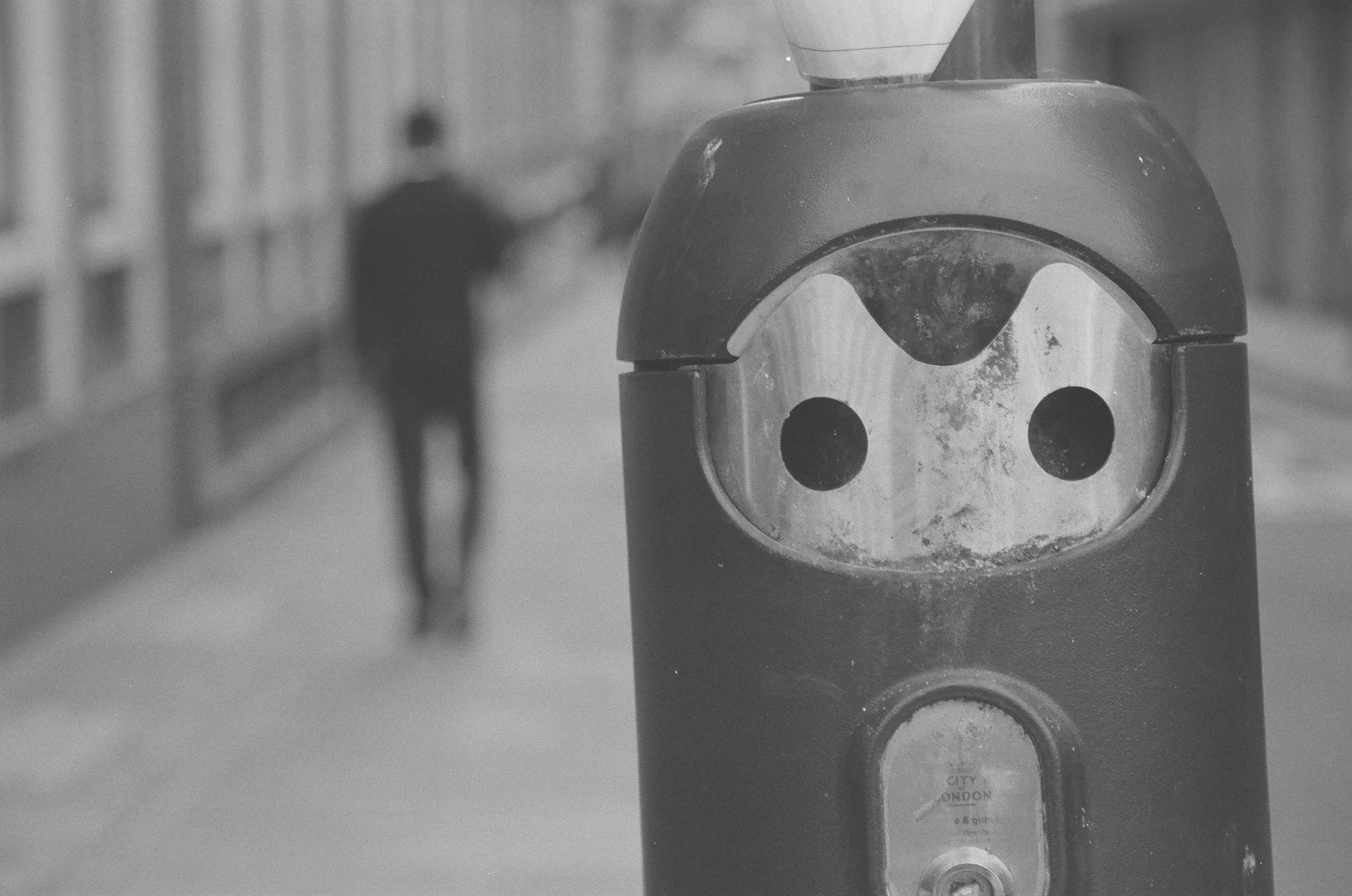 Sample photo of AgfaPhoto APX 400 35mm film showing a cigarette bin in foreground with a blurred figure in background
