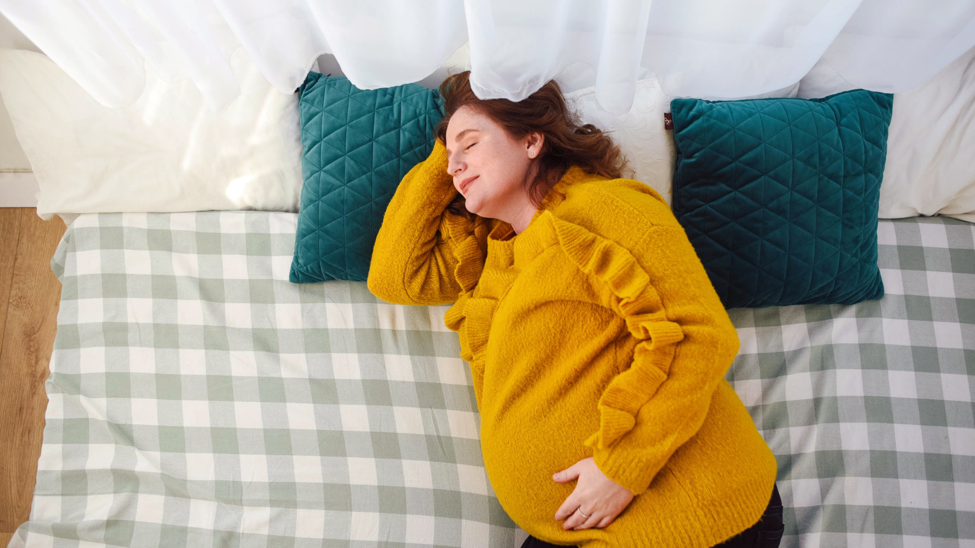 Pregnant woman sleeping in a bright lit room