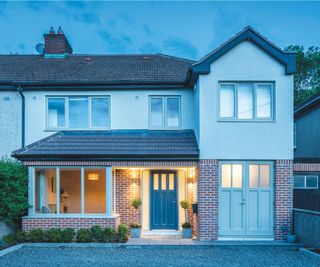 double storey garage conversion on semi-detached house with render and brick exterior