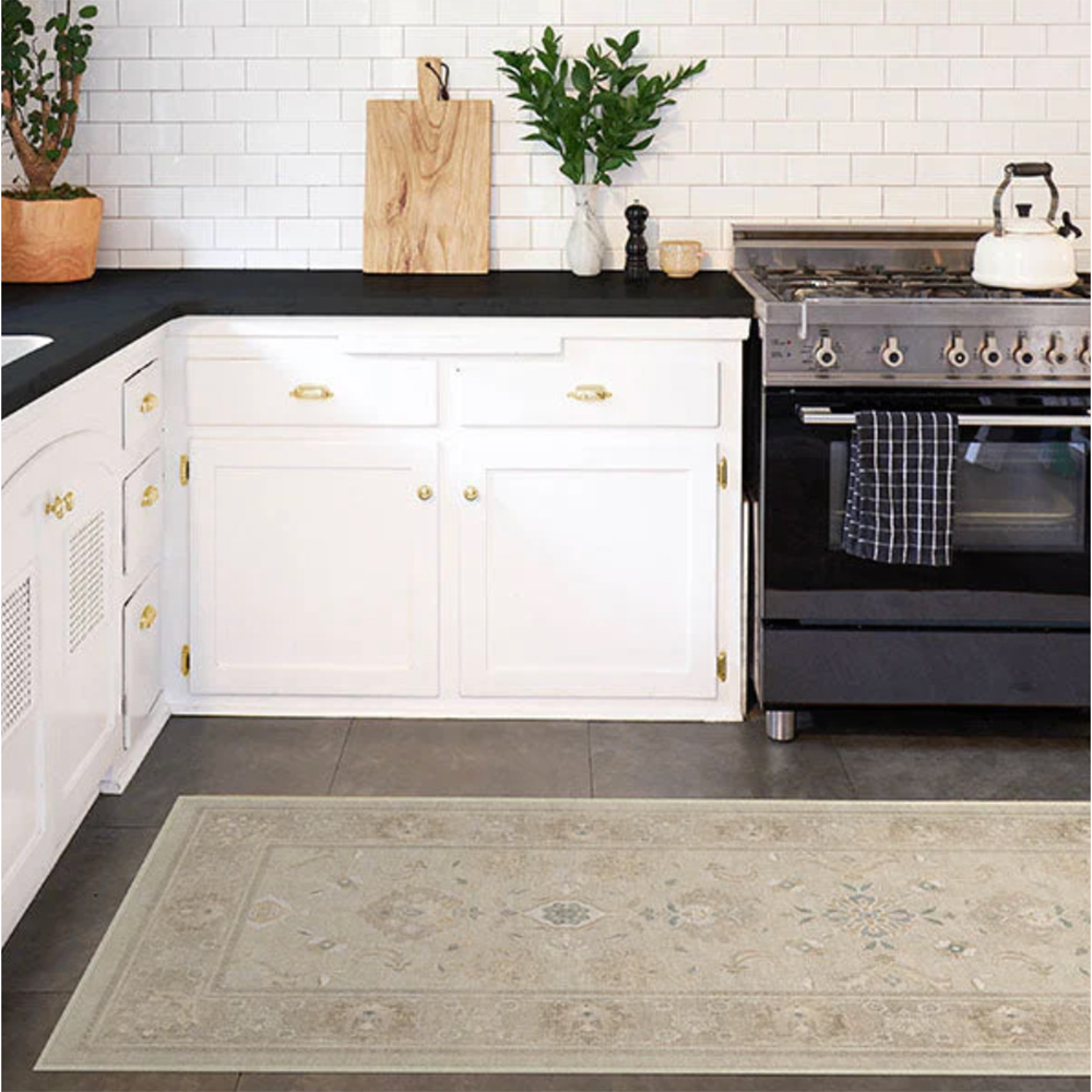 White kitchen with black marble worktops and a patterned floor runner