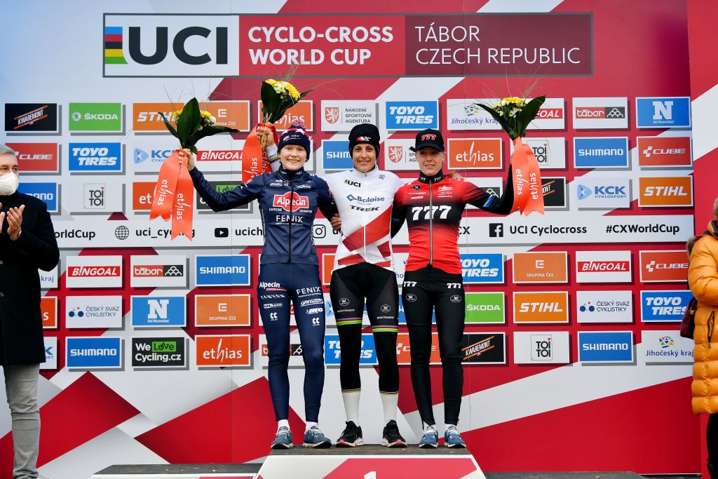 TABOR CZECH REPUBLIC NOVEMBER 14 LR Puck Pieterse of The Netherlands and Team AlpecinFenix on second place race winner Lucinda Brand of The Netherland and Team Baloise Trek Lions and Annemarie Worst of The Netherlands and Team 777 on third place pose on the podium during the podium ceremony after the 25th Tabor UCI CycloCross Worldcup 2021 Womens Elite CXWorldCup on November 14 2021 in Tabor Czech Republic Photo by Luc ClaessenGetty Images
