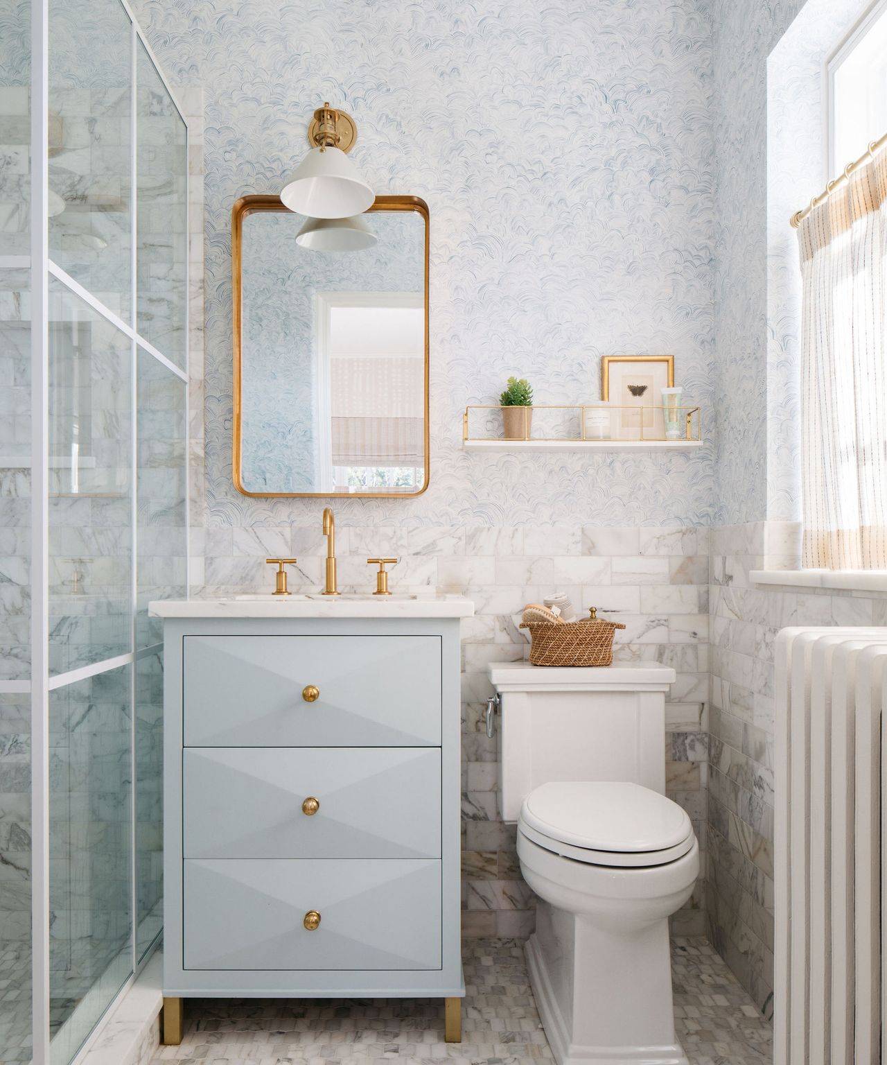 Small light blue bathroom with table and shower